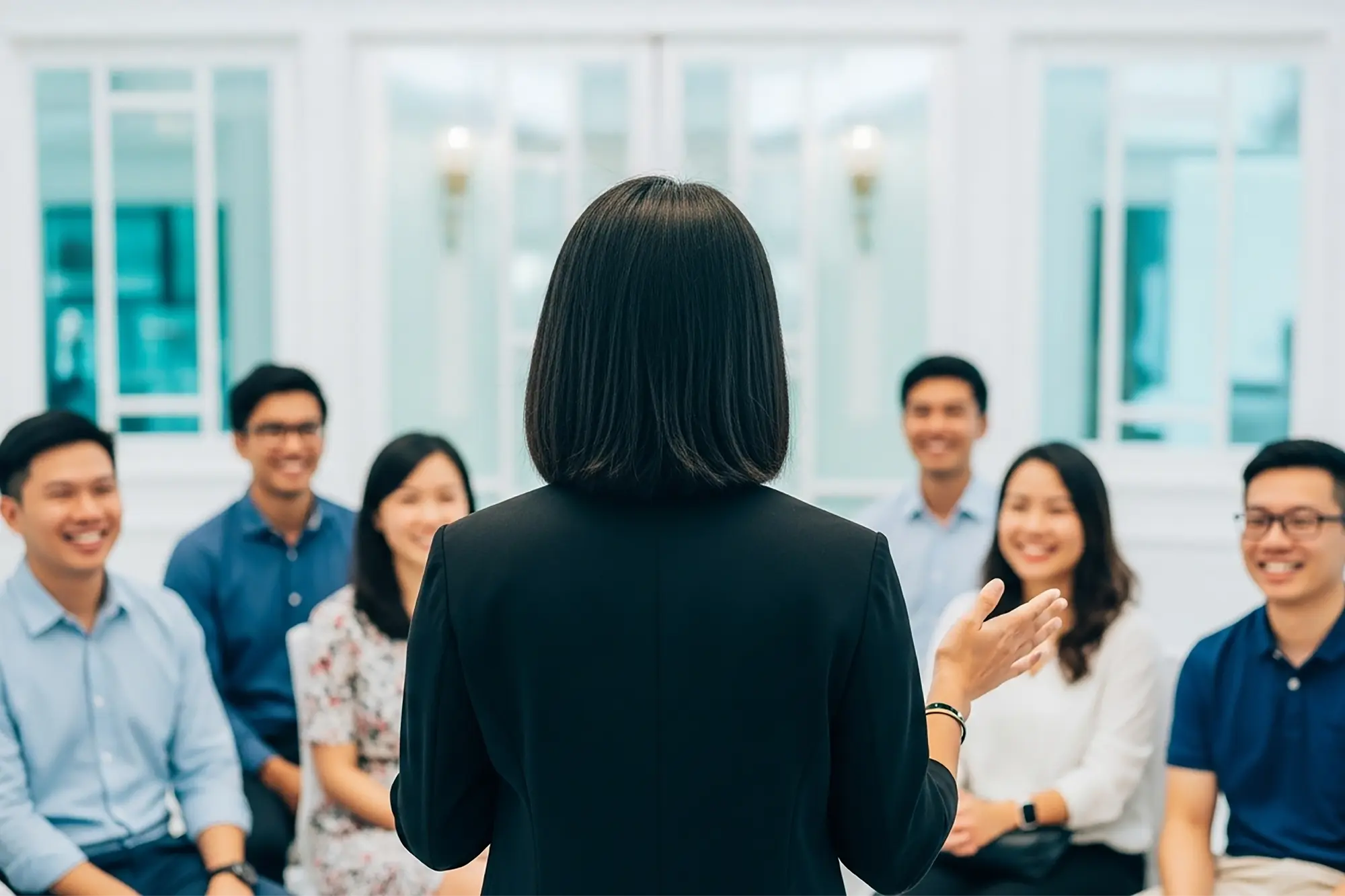 A woman speaking to her coachees
